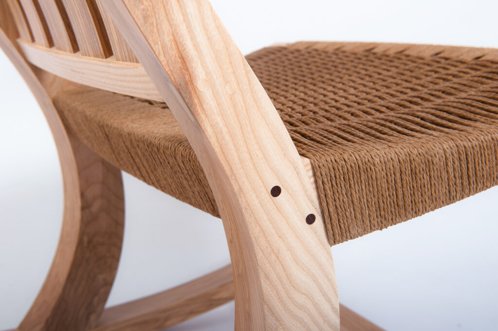 A CLOSEUP OF THE CORD WOVEN SEAT ON A ROCKING CHAIR MADE ON A FINE FURNITURE MAKING COURSE AT ROWDEN ATELIER