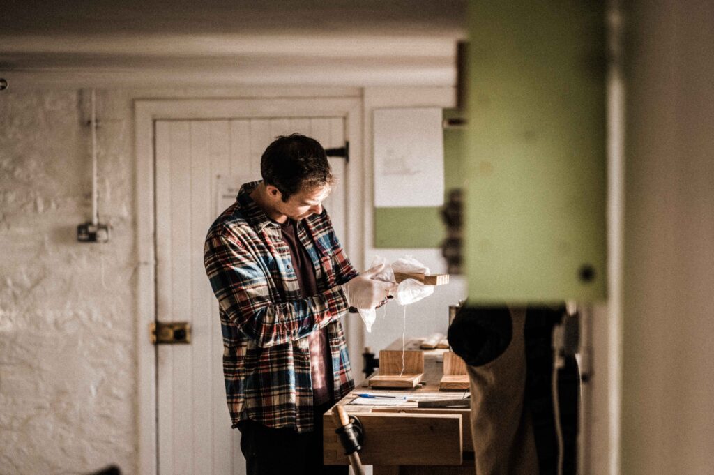 A STUDENT FINSHING ONE OF THE HAND TOOL WOODWORKING PROJECTS ON A WOODWORKING COURSE AT ROWDEN ATELIER