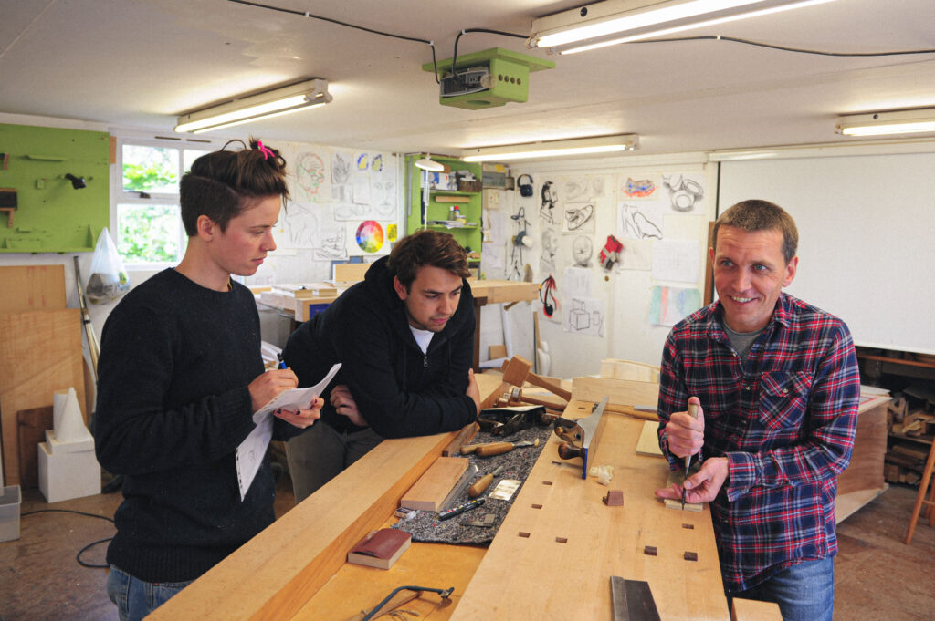 Rowden tutor Daren Millman demonstrating cutting dovetails to students in the workshop