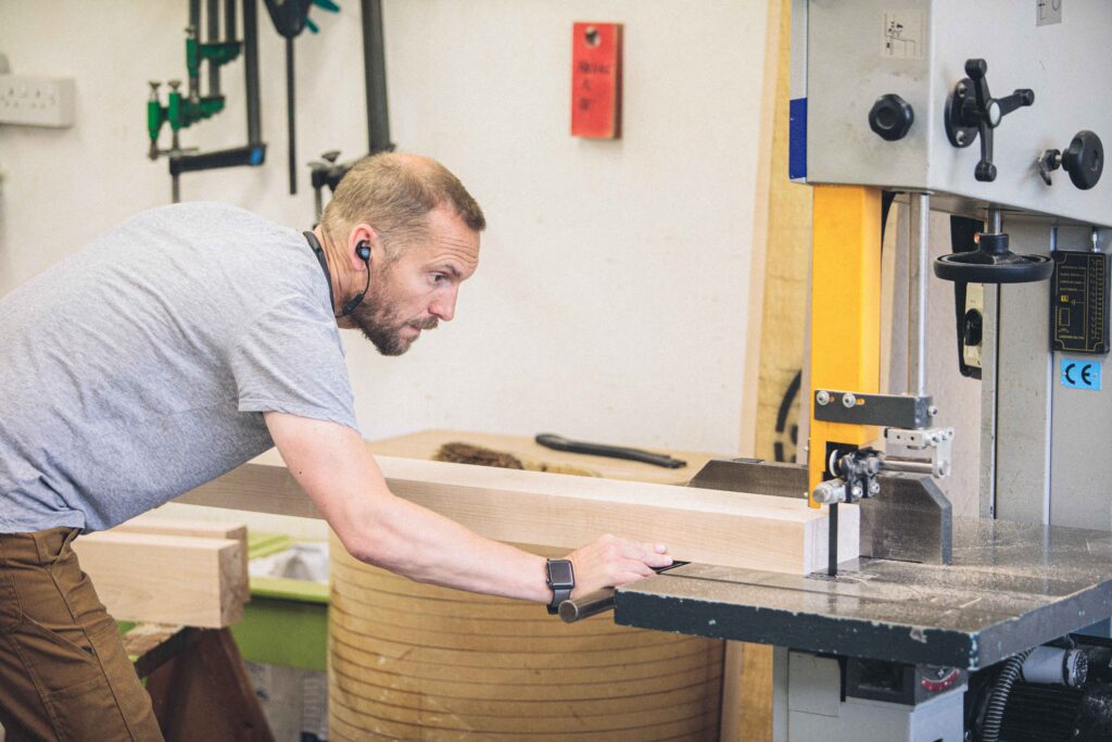 Rowden student using the bandsaw in a fine woodworking course