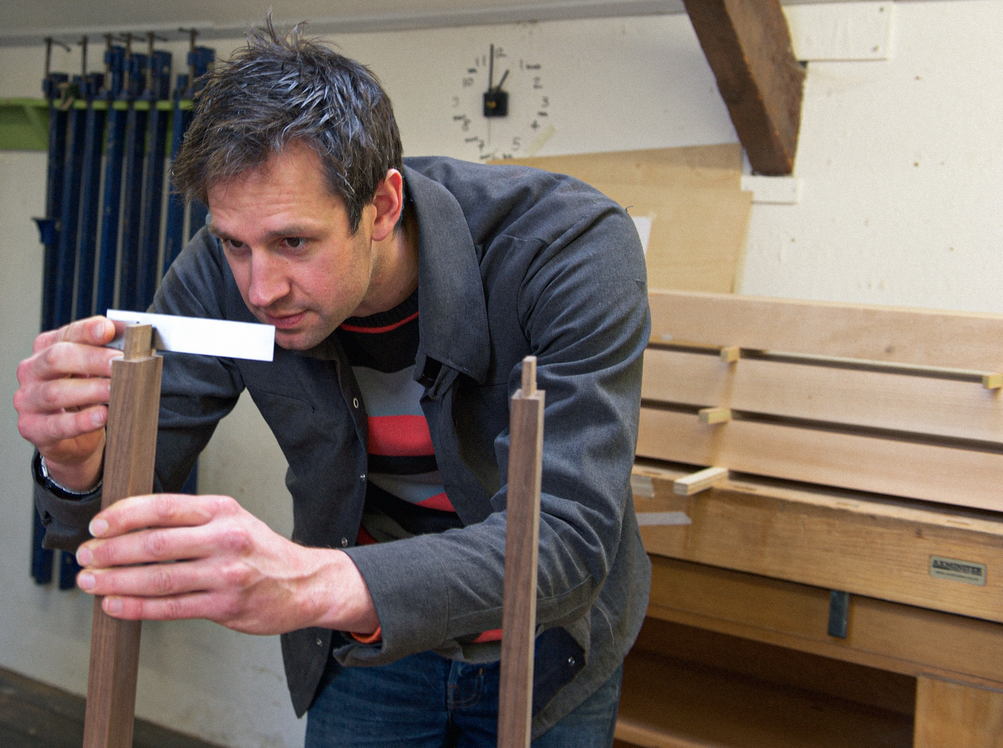 Rowden tutor Ed Wild checking a shoulder for square on a piece of furniture, made on a furniture making course at Rowden Atelier