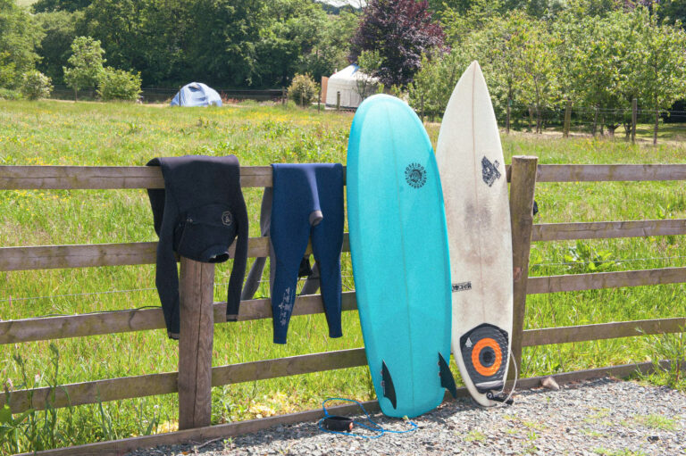 Surfboards and wetsuits outside Rowden Atelier