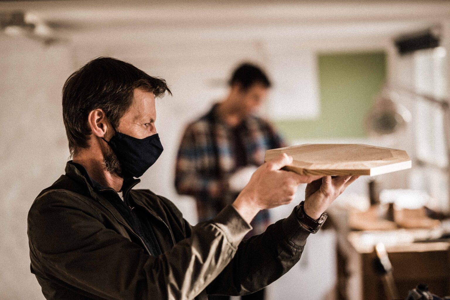 a tutor at Rowden checks accuracy of student work on a woodworking course at Rowden Atelier.