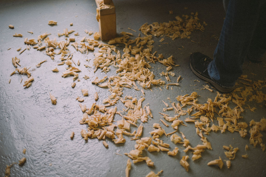 wood shavings under a student, learning woodworking at Rowden Atelier