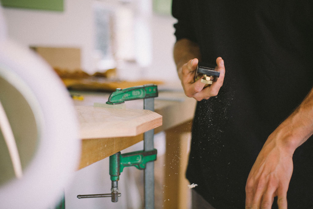 A student clears their block plane, whilst making a piece on a fine woodworking course at Rowden Atelier